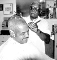 Harvey Tucker trims Royce Smith's hair
